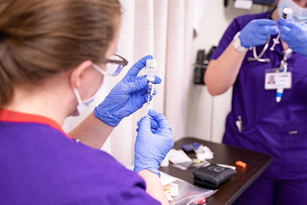 Nursing students filling vial