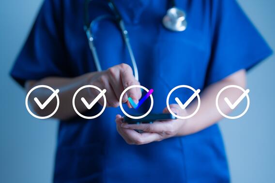 Nurse using phone selecting a checkmark